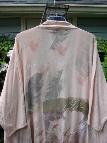 Barclay NWT Art Kimono Wind Dust Hush Pink Slub OSFA displayed on a hanger with a visible stain on the front. The shirt features dolman sleeves, emphasizing its unique, vintage Blue Fish Clothing style.
