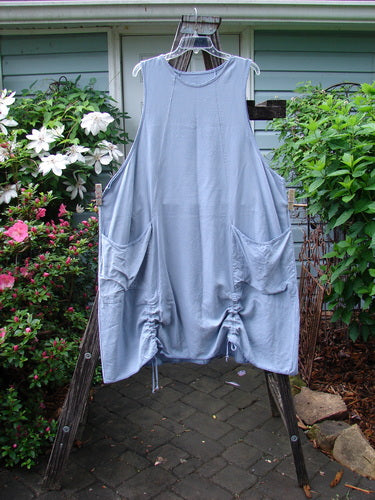 Barclay Lyocell Sectional Pocket Venetian Jumper Unpainted Sky Size 2 features unique curvy seams, drop front pockets, deeper arm openings, and A-line shape on a clothes rack.