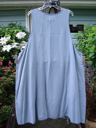 Barclay Lyocell Sectional Pocket Venetian Jumper Unpainted Sky Size 2 hanging on a clothesline, featuring unique figure-eight seams and drop front pockets, epitomizing vintage Blue Fish Clothing's creative freedom.