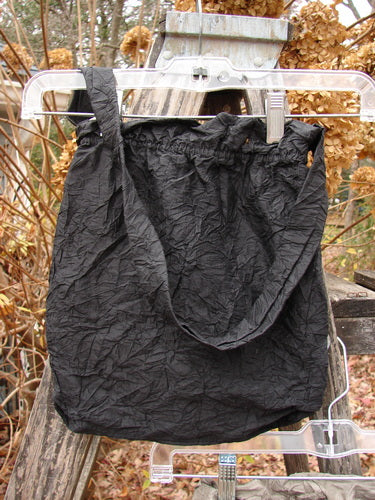 2000 NWT Shaunting Silk Bag in Black featuring a gathered top and medium shoulder strap, showcased outdoors, capturing the vintage elegance and creative spirit of BlueFishFinder.com's unique collection.