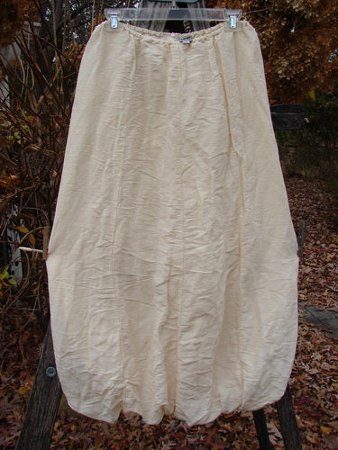 2000 Hemp Silk Reverse Skirt Unpainted Parchment Size 1, showcasing a lightweight, slightly crinkled fabric with a gathered bubble hem, hanging outdoors, highlighting its elegant, textured double-layered hemp silk design.