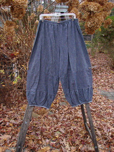 Barclay Hemp Cotton Meadow Pant Unpainted Black Stripe Size 1: Loose-fitting, wide-leg denim pants with pinstripe pattern, pleated waist, and cinched hems, displayed outdoors on a wooden ladder amid autumn leaves and dried hydrangeas.