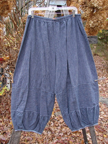 Barclay Hemp Cotton Meadow Pant Unpainted Black Stripe Size 1, showcasing loose-fit harem-style silhouette with an elastic waistband and cuffs, hanging outdoors amidst garden foliage, perfect for spring or summer wear.