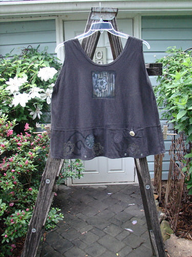 1995 Klee Top Flower Power Shadow Altered Size 2 displayed on a wooden ladder, showcasing its swingy A-line crop shape, scooped neckline, and distinctive hand-stamped ceramic button on the pocket.