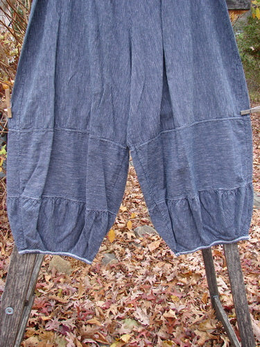 Barclay Hemp Cotton Meadow Pant Unpainted Black Stripe Size 1, loose-fitting with pinstripes, wide legs gathered at cuffs, displayed over an outdoor wooden ladder with autumn leaves scattered below.