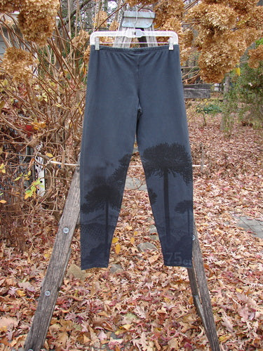 Barclay Cotton Lycra Straight Pant Shadow Tree Lux Silhouette Size 1 displayed on a white hanger, featuring a subtle tree-silhouette pattern from mid-shin, set against an autumnal garden backdrop.