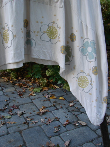 Barclay Cotton Lycra Double Pocket Bounce Tunic Dress Floral Creme Size 2, featuring oversized front pockets, curvy seams, and festive floral garden patterns in soft pastels with bright accents.