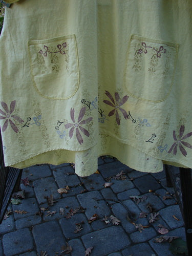 Barclay Linen Duet Sunrise Dress Roman Goddess Sunshine Size 2, featuring a ruffled neckline, vertical pleats, empire waistline, two front pockets, and a floral Roman goddess theme in tightly woven linen fabric.