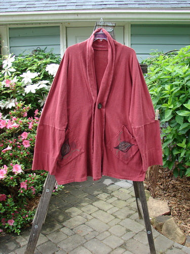 1995 Reprocessed Deco Jacket Antique Car and Leaf Hollyberry OSFA displayed on a wooden stand, showcasing its dense cotton texture, deep V neckline, oversized pockets, and long arm lengths.
