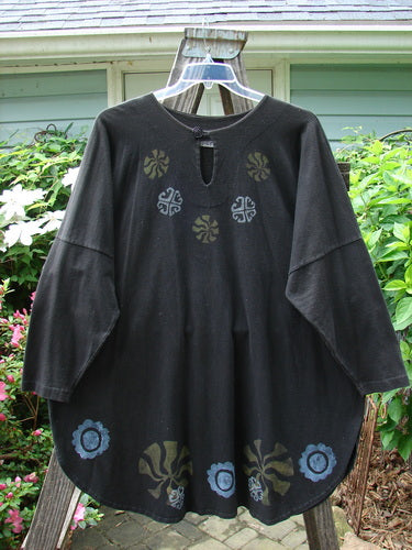 1997 Masquerade Top Celtic Continuum Obsidian OSFA, features a teardrop neckline with button closure, drop shoulder seams, rounded hemline, vented sides, and a drawcord back with Celtic-themed patterns.