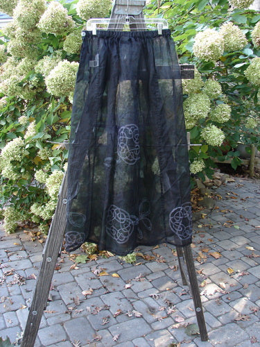 2000 NWT Silk Organza Skirt Wind Turn Celtic Turn Black Size 2 displayed on a wooden stand, highlighting its A-line flare, full elastic waistline, and sheer, plum-hued fabric with vertical panels.