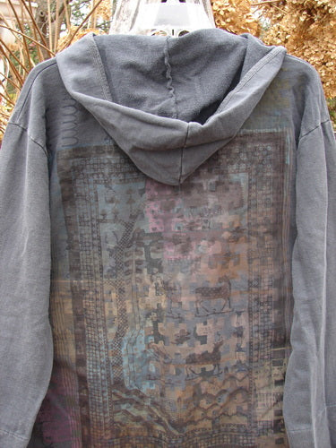 Barclay NWT Favorite Pocket Hoodie Primitive Pony Block Shadow Size 0, featuring a faded charcoal hue, geometric multicolored back graphic, textured inner, scooped hemline, and front drop pockets, hanging outdoors.