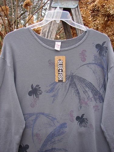 Barclay NWT Modal Organic Cotton Sketchbook Top in Dragonfly Haze, Size 1, featuring long sleeves, a rounded neckline, and artistic floral motifs in darker hues, hanging on a clear plastic hanger.