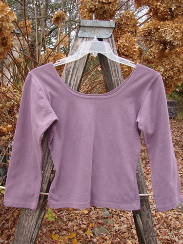 1994 Cotton Lycra Ballerina Layering Top Plave Smaller Size 2, displayed on a clear hanger outdoors. The top features long sleeves, a ballerina neckline, and a tapering waist, emphasizing its fitted design.