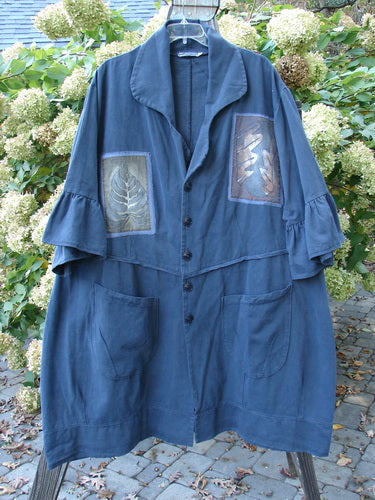 Barclay PMU Patched Twill Decora Brushed Flutter Coat Fall Leaf Navy Size 2 displayed on a hanger, showcasing its ruffled 3/4 length sleeves, deep V neckline, and large pockets.