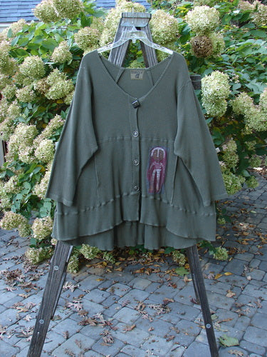 Barclay Patched Thermal Touring Cardigan Lucky Guy Pond Green OSFA displayed on a rack, showcasing its unique flared hem, deep V-neck, vintage buttons, and kangaroo-style pocket.
