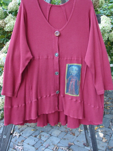 Barclay Patched Thermal Touring Cardigan in Ruby Red, featuring a flared hem, deep V-neck with vintage buttons, and a front kangaroo pocket, showcasing a unique Lucky Guy theme patch.