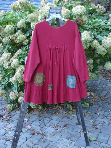 Barclay Patched Thermal Touring Cardigan Lucky Guy Ruby Red OSFA, featuring a unique flared hem, deep V-neck with vintage buttons, and a draw cord back, displayed on a rack.