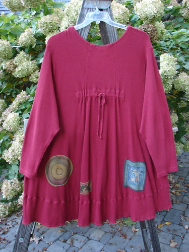 Barclay Patched Thermal Touring Cardigan Lucky Guy Ruby Red OSFA displayed on a clothes rack, showcasing its unique patches, flared hem, and mixed vintage buttons.