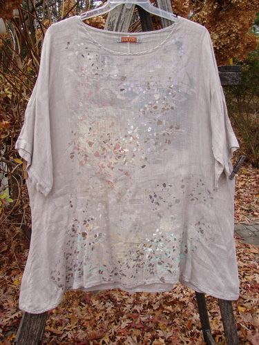 Barclay Lightweight Linen Tea Time Top in Fall Rain Sand, Size 1, features a flowy A-line shape, subtle metallic pattern, scoop neckline, and short sleeves, displayed outdoors on a hanger.