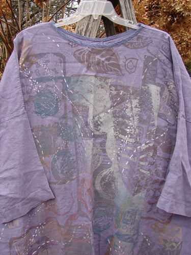 Barclay Linen Oversized Gallery Dress Home Fall Violet OSFA features a washed-out lavender tunic with abstract motifs, rounded neckline, drop shoulders, and three-quarter dolman sleeves, hanging outdoors.