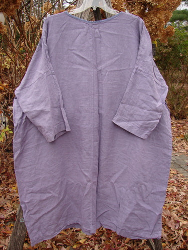 Barclay Linen Oversized Gallery Dress Home Fall Violet OSFA, featuring a loose-fitting silhouette with three-quarter dolman sleeves and a rounded neckline, displayed on a hanger against a natural backdrop.