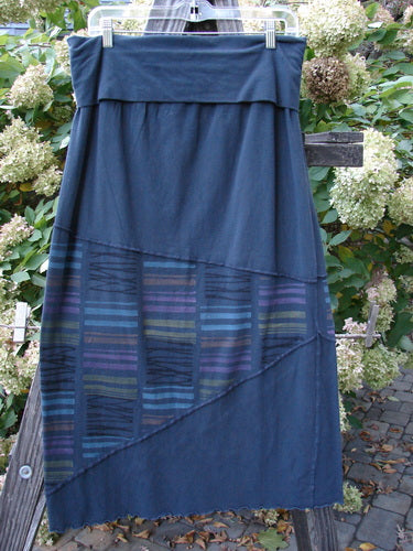 Barclay Cotton Lycra Fold Over Column Skirt Zig Zag Stripe Blue Mineral Size 1 on a clothes rack, showcasing its zig-zag stitchery, stripe triangular accents, and full circumference lettuce edge.