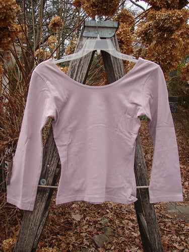 1994 Cotton Lycra Ballerina Layering Top Unpainted Plave Smaller Size 2, featuring a scoop-neck and quarter-length sleeves, displayed on a wooden trellis, highlighting its shapely fit and forgiving stretch fabric.