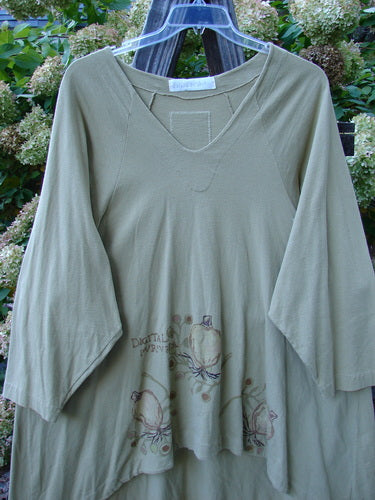 1998 Botanicals Bell Flower Top Root Berry Seed Size 2 displayed on a hanger, featuring long sleeves, a softly rounded neckline, and a belled A-line shape with a scooped front hemline.