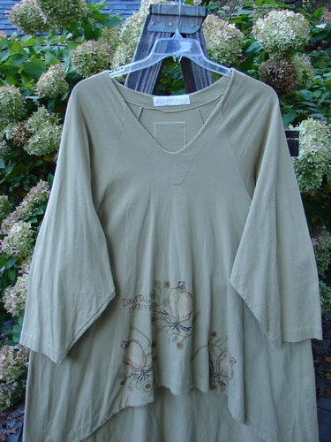 1998 Botanicals Bell Flower Top Root Berry Seed Size 2 displayed on a swing, featuring a softly rounded neckline, upward scooped front hem, and sectional panels with a blue fish patch at the back.