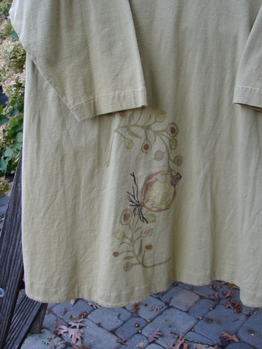 1998 Botanicals Bell Flower Top Root Berry Seed Size 2 featuring a long-sleeved white shirt with a botanical design, belled A-line shape, scooped front hemline, and blue fish patch at the back.