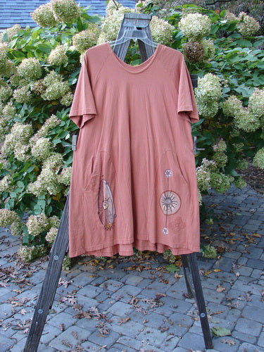 1998 4 Elements Tress Dress Starburst Arausio Size 2 displayed on a wooden stand, showcasing its A-line shape, side entry front pockets, and scooped neckline.