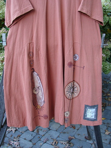 Close-up of the 1998 4 Elements Tress Dress Starburst Arausio Size 2, showcasing the A-line shape, front pockets, elongating skirt insets, and a gently scooped neckline with a signature Blue Fish patch.