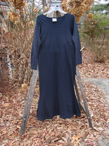 1992 Pedestal Dress Unpainted Black Size 1, displayed on a wooden ladder among hydrangeas, features a scoop neck, empire waist, and unique fish tail flutters, highlighting Bluefishfinder.com's vintage elegance.