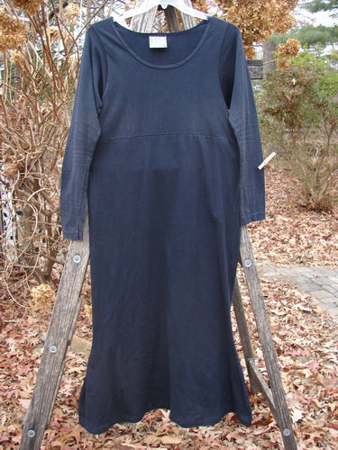 1992 Pedestal Dress Unpainted Black Size 1, featuring a scooped neckline and empire seam, with a flared skirt, displayed outdoors, embodying vintage elegance from Bluefishfinder.com's Fall Collection.