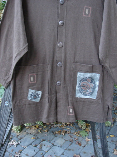 1996 Everyday Jacket Inner Woman Molasses Size 2: A brown shirt with a patch on it, featuring scribe buttons, oversized exterior painted drop pockets, and the signature Blue Fish patch.