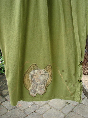 1993 Tie Jumper Mythical Goddess Olive Size 2 featuring a green fabric with a painted angel, thicker shoulder straps, a squared bib with velvet ribbon ties, and an empire waist seam.