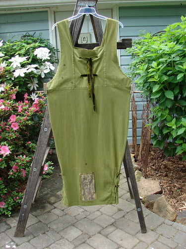 1993 Tie Jumper Mythical Goddess Olive Size 2 displayed on a ladder, featuring thick shoulder straps, velvet ribbon ties, a squared bib, and mythical goddess theme paint.