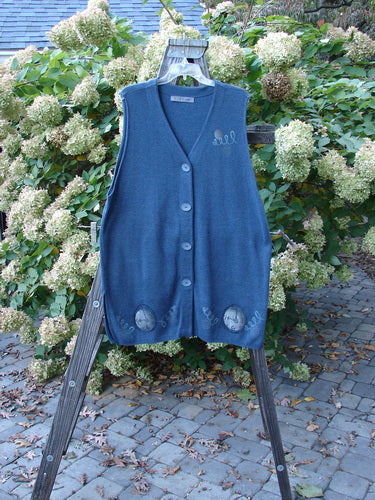 1997 Cashmere Archway Vest with pocket watch theme buttons on a wooden stand, made from soft and durable Blue Fish Cotton Cashmere.