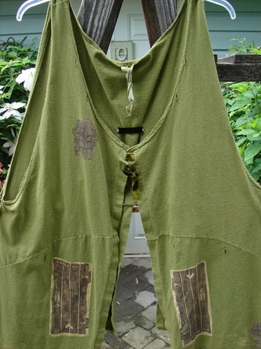 1993 Holy Vest Mythical Door Olive Size 2: Green overalls with unique patch designs, open sides, and velvet ribbon accents, hanging on a clothesline, showcasing the vintage style of Bluefishfinder.com.