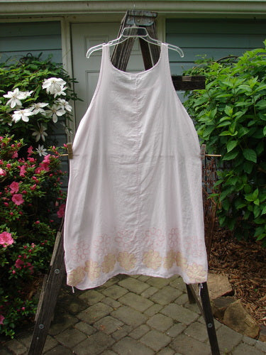 Barclay Batiste Round Neck Tie Up Shift Daisy Power Pink Cloud Size 2 on a clothes rack, showcasing its rounded neckline, vertical seams, and lower hem side gathers.