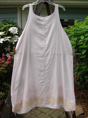 Barclay Batiste Round Neck Tie Up Shift Daisy Power Pink Cloud Size 2 hanging on a clothesline, showcasing its round neckline, lower hem gathers, and vertical center seams.