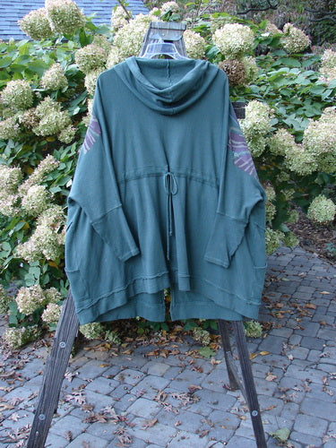 Barclay Fleece Hooded Zip Jacket Giant Daisy Pond Moss OSFA displayed on a rack, showcasing its generous hood, full zipper front, and lower pockets with Celtic Moss accents.