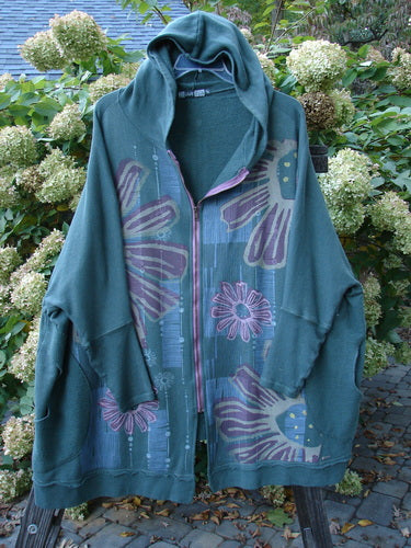 Barclay Fleece Hooded Zip Jacket Giant Daisy Pond Moss OSFA displayed on a hanger, showcasing its cozy hood, full zipper front, roomy drop pockets with Celtic Moss accents, and unique metallic daisy design.
