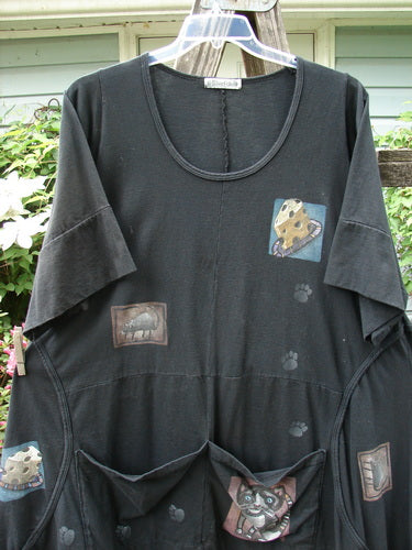 Barclay Double Pocket Bounce Tunic Dress Cat & Mouse Black Size 2 features cheese and paw prints on a black medium-weight organic cotton fabric, including wrap-around seams and oversized front pockets.