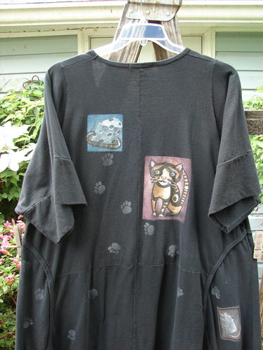 Barclay Double Pocket Bounce Tunic Dress Cat & Mouse Black Size 2, featuring wrap-around seams, oversized pockets, and cat and mouse illustrations on a black medium-weight organic cotton fabric.
