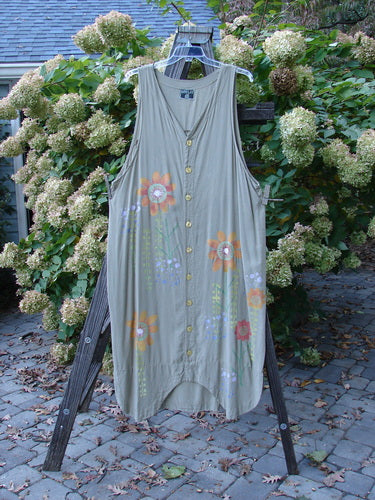 Image alt text: Barclay Tencel Long Vent Vest Tall Stem Floral Seed Size 1 - A dress on a rack, featuring a grey dress with flowers on it, close-up of the dress, and a leaf on a brick surface.