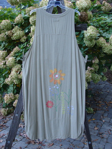 A Barclay Tencel Long Vent Vest in Seed with a deep V neckline, elongating arm openings, and a scalloped hemline adorned with tall stem florals.