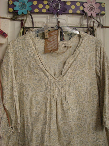 Magnolia Pearl NWT European Cotton Bondi Blouse Fleuri OSFA on a polka dot rack, showcasing its raw-edged V neckline, pintuck accents, and floral block print in soft, pastel hues.