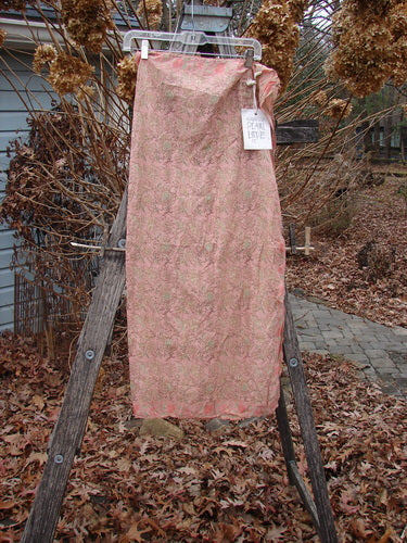 Magnolia Pearl NWT European Cotton MP Block Print Scarf Rosette draped on a ladder, showcasing its delicate floral print and flowing, sheer fabric in a serene garden setting.